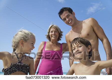 Multi-generation family having fun at the beach View Large Photo Image Stock Image - Multi-generation family having fun at the beach. Fotosearch