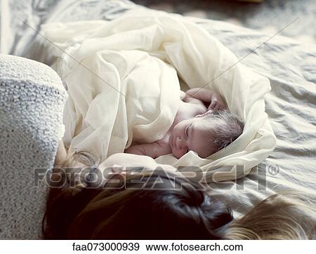 New born baby and mother resting in bed View Large Photo Image Stock Photo - New born baby and mother resting in bed. Fotosearch