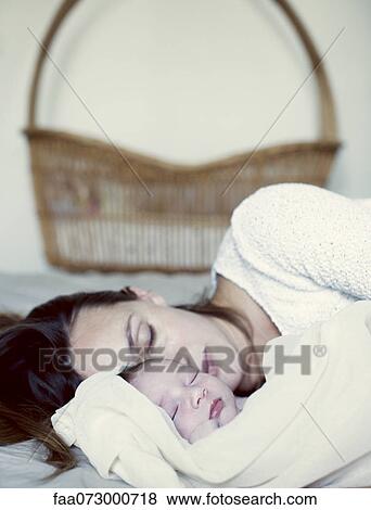 New born baby and mother sleeping in bed View Large Photo Image Stock Photo - New born baby and mother sleeping in bed. Fotosearch