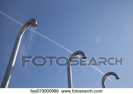 Stock Image - Outdoor public showers. Fotosearch