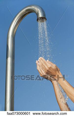 Person holding hands under public shower View Large Photo Image Stock Image - Person holding hands under public shower. Fotosearch
