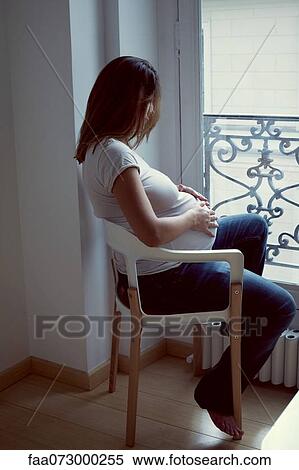Pregnant woman caressing abdomen, side view View Large Photo Image Stock Photography - Pregnant woman caressing abdomen, side view. Fotosearch