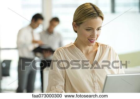Stock Image - Professional woman working in office. Fotosearch
