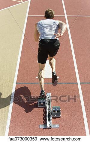 Runner at starting line, rear view View Large Photo Image Stock Photo - Runner at starting line, rear view. Fotosearch