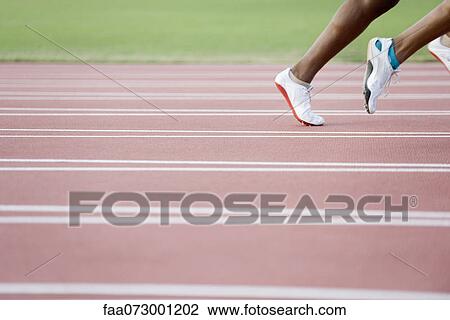 Stock Image - Runners on track, cropped. Fotosearch