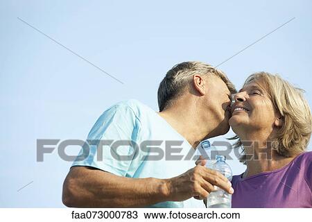 Senior man kissing wife's cheek View Large Photo Image Stock Image - Senior man kissing wife's cheek. Fotosearch