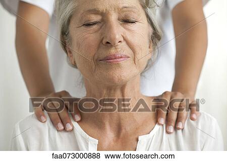 Senior woman getting a shoulder massage View Large Photo Image Stock Photo - Senior woman getting a shoulder massage. Fotosearch