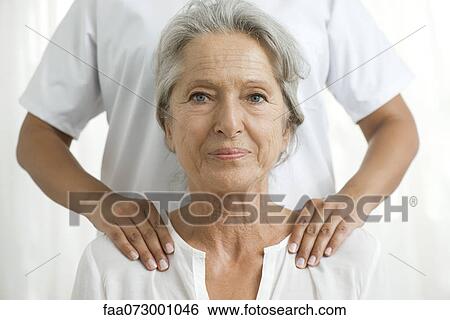 Senior woman getting a shoulder massage View Large Photo Image Stock Photograph - Senior woman getting a shoulder massage. Fotosearch