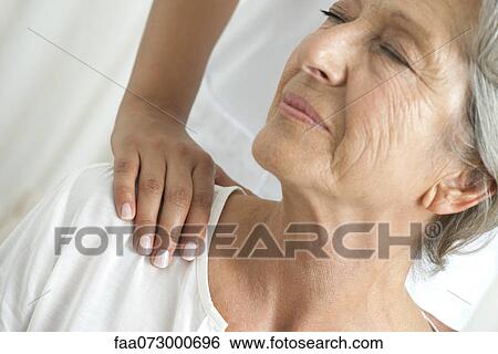 Senior woman getting a shoulder massage, cropped View Large Photo Image Stock Photograph - Senior woman getting a shoulder massage, cropped. Fotosearch