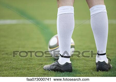 Soccer player standing on field, low section View Large Photo Image Stock Image - Soccer player standing on field, low section. Fotosearch