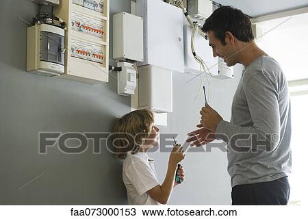 Son helping father with home improvement View Large Photo Image Stock Image - Son helping father with home improvement. Fotosearch