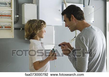Son helping father with home improvement View Large Photo Image Stock Image - Son helping father with home improvement. Fotosearch