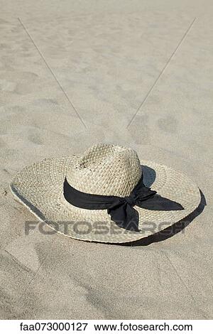 Straw hat on beach View Large Photo Image Stock Photo - Straw hat on beach. Fotosearch