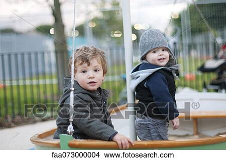Picture - Toddler boys playing on playground. Fotosearch