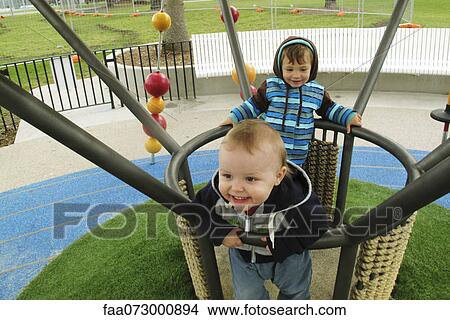 Picture - Toddler boys playing on playground. Fotosearch