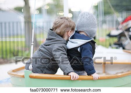 Stock Image - Toddler boys playing on playground. Fotosearch