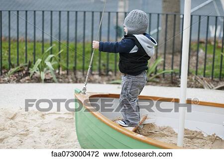 Stock Image - Toddler playing on boat. Fotosearch