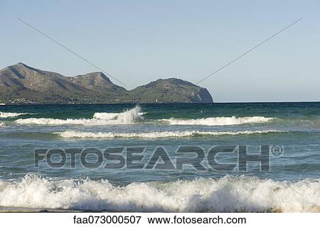 Stock Photo - View of ocean, mountain in background. Fotosearch