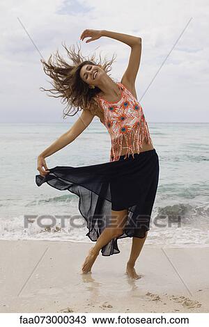 Woman dancing and tossing hair on beach View Large Photo Image Stock Image - Woman dancing and tossing hair on beach. Fotosearch