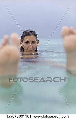 Woman floating in water, portrait View Large Photo Image Stock Image - Woman floating in water, portrait. Fotosearch