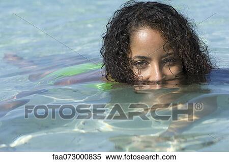 Woman in water with only eyes above water View Large Photo Image Stock Photography - Woman in water with only eyes above water. Fotosearch