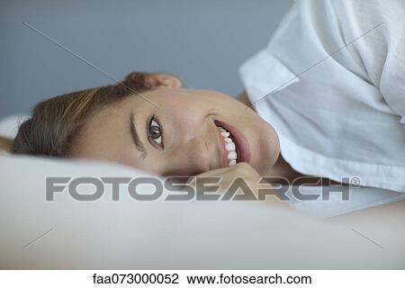 Woman lying on side, portrait View Large Photo Image Stock Image - Woman lying on side, portrait. Fotosearch
