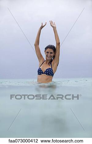 Woman playing in water, portrait View Large Photo Image Stock Image - Woman playing in water, portrait. Fotosearch