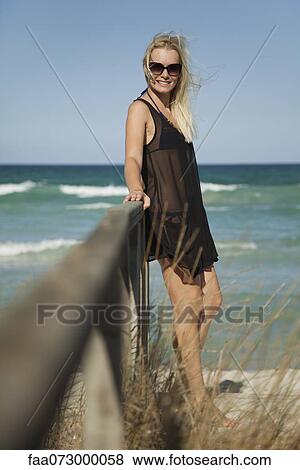 Woman relaxing at the beach View Large Photo Image Stock Photo - Woman relaxing at the beach. Fotosearch