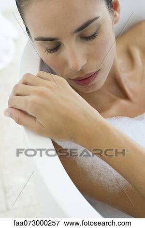 Woman relaxing in bubble bath View Large Photo Image Stock Photo - Woman relaxing in bubble bath. Fotosearch