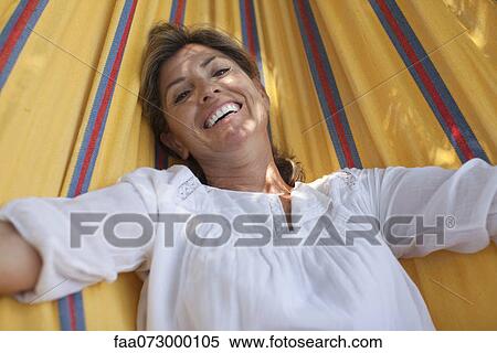 Woman relaxing in hammock, portrait View Large Photo Image Stock Photography - Woman relaxing in hammock, portrait. Fotosearch