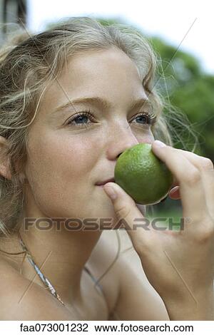 Woman smelling lime View Large Photo Image Stock Image - Woman smelling lime. Fotosearch