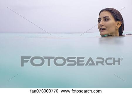 Stock Image - Woman swimming, portrait. Fotosearch