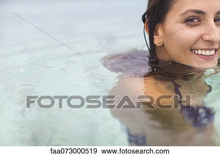 Stock Photo - Woman swimming, portrait. Fotosearch