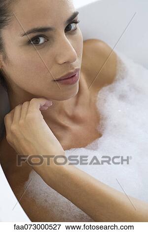 Stock Photo - Woman taking bubble bath. Fotosearch