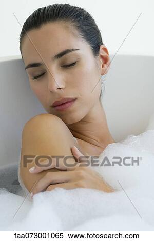 Woman taking bubble bath with eyes closed View Large Photo Image Stock Photography - Woman taking bubble bath with eyes closed. Fotosearch