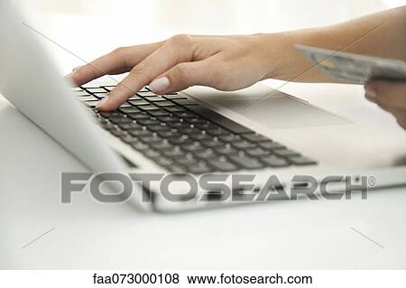 Woman using laptop computer to make an internet purchase, cropped View Large Photo Image Stock Photo - Woman using laptop computer to make an internet purchase, cropped. Fotosearch