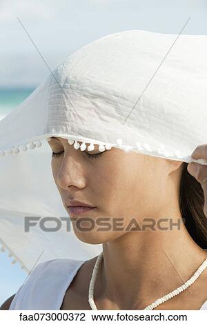 Stock Image - Woman wearing veil, eyes closed, portrait. Fotosearch