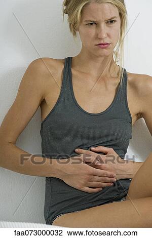 Woman with hands on stomach View Large Photo Image Stock Image - Woman with hands on stomach. Fotosearch