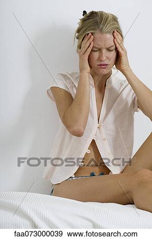 Stock Photo - Woman with head in hands and eyes closed. Fotosearch