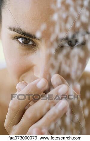 Woman's face behind running water View Large Photo Image Stock Photo - Woman's face behind running water. Fotosearch