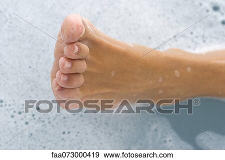 Stock Photo - Woman's foot in bath, directly above. Fotosearch