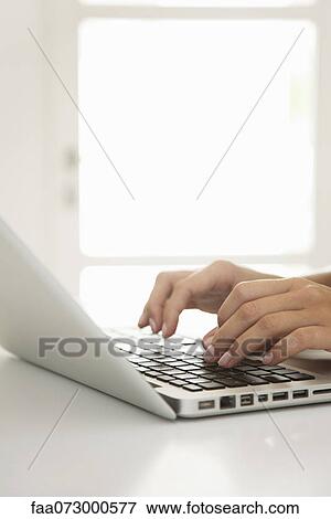 Woman's hands typing on laptop computer View Large Photo Image Stock Photo - Woman's hands typing on laptop computer. Fotosearch