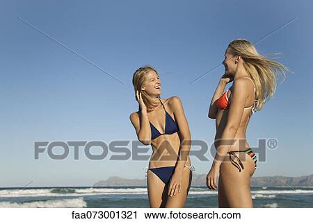 Stock Image - Women together at the beach. Fotosearch