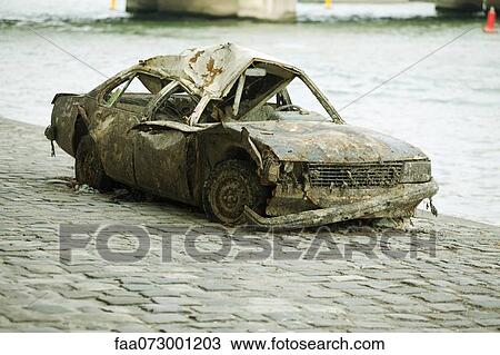 Wrecked car on waterfront View Large Photo Image Stock Image - Wrecked car on waterfront. Fotosearch