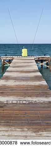 Yellow suitcase at end of dock View Large Photo Image Stock Photo - Yellow suitcase at end of dock. Fotosearch