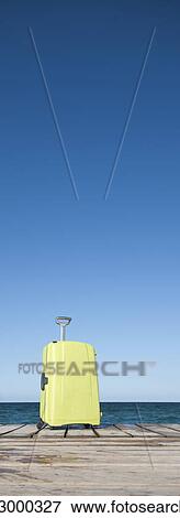 Yellow suitcase on pier View Large Photo Image Stock Photo - Yellow suitcase on pier. Fotosearch