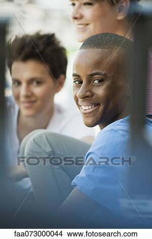 Young man hanging out with friends View Large Photo Image Picture - Young man hanging out with friends. Fotosearch