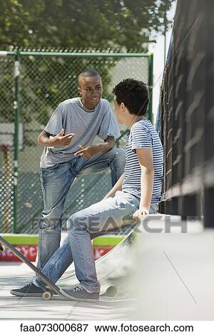 Young men talking View Large Photo Image Stock Photo - Young men talking. Fotosearch