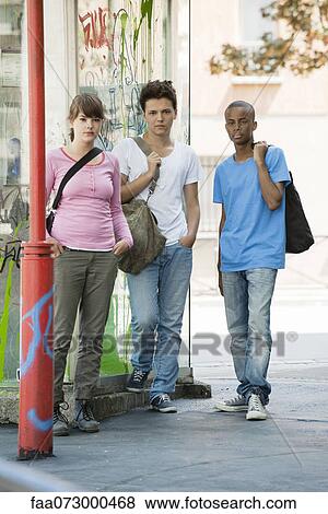 Stock Photo - Young people standing side by side. Fotosearch