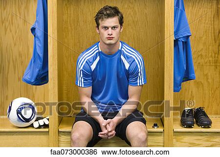Young soccer player sitting in locker room, portrait View Large Photo Image Stock Photograph - Young soccer player sitting in locker room, portrait. Fotosearch